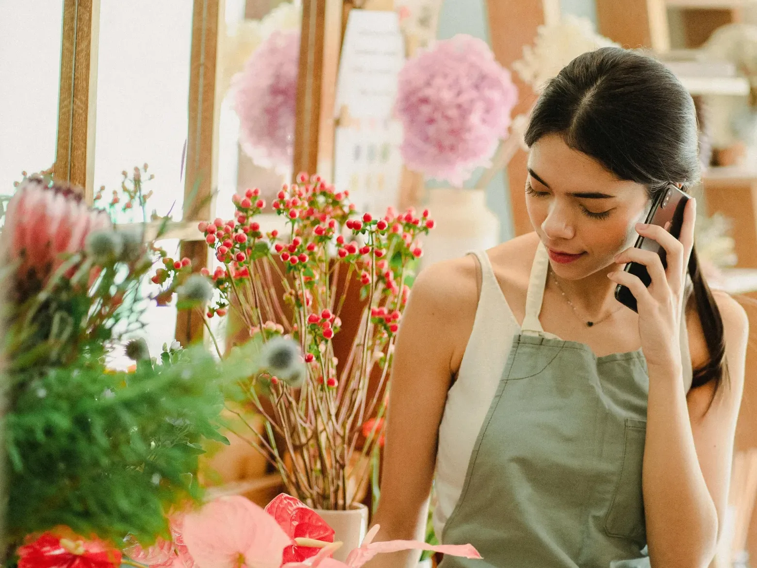 A business owner taking a phone call in her shop
