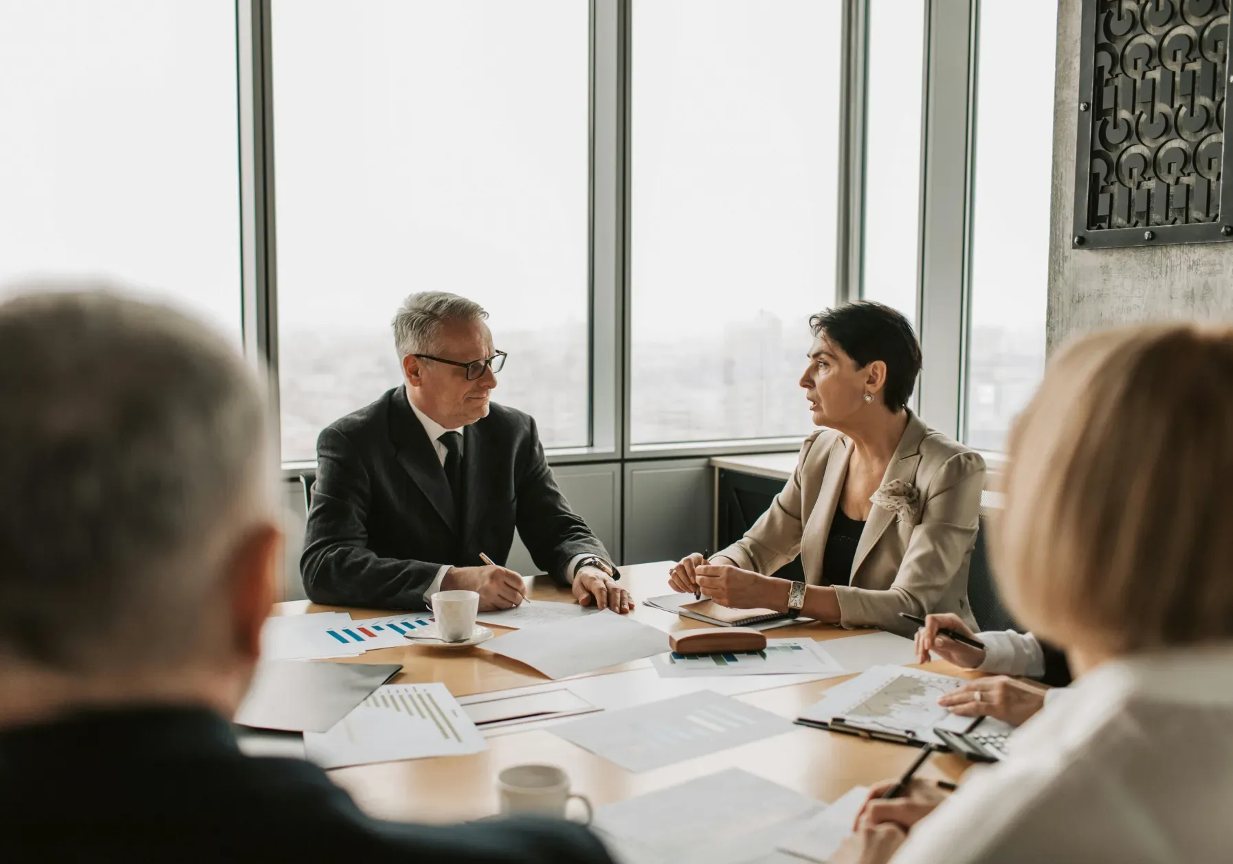 Advisers meeting around a table in an office