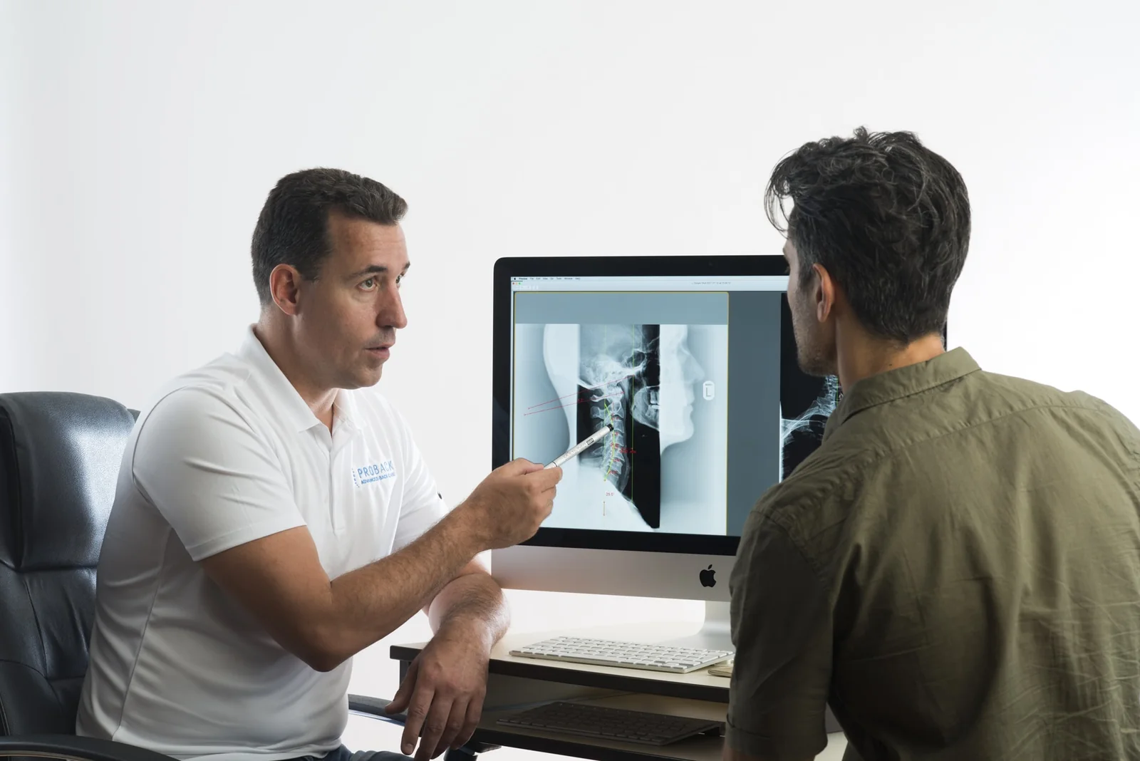 Dr Christian Allard talking a patient through their x-ray