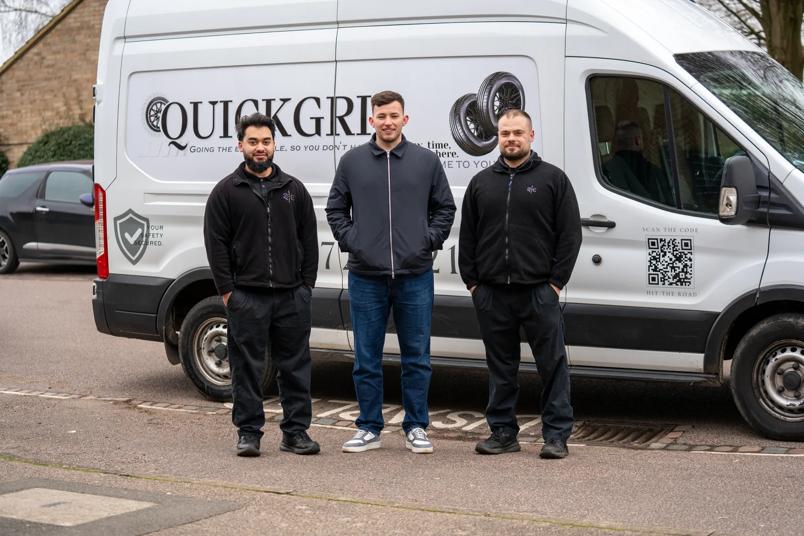 The QuickGrip team standing in front of their van