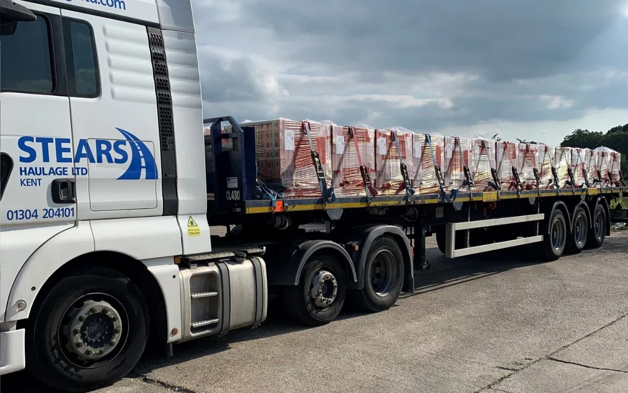 A Stears Haulage flatbed loaded with pallets of bricks