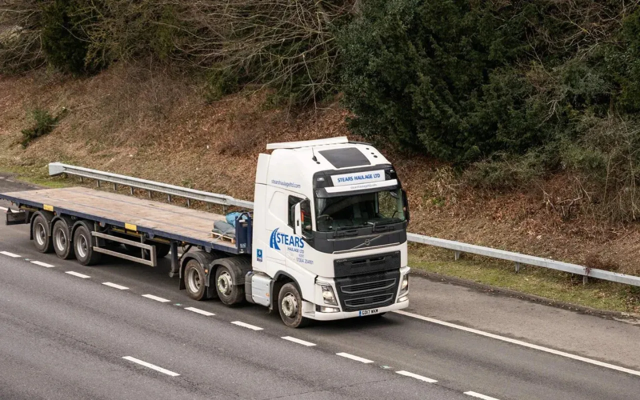 An empty Stears Haulage flatbed on a dual carriageway