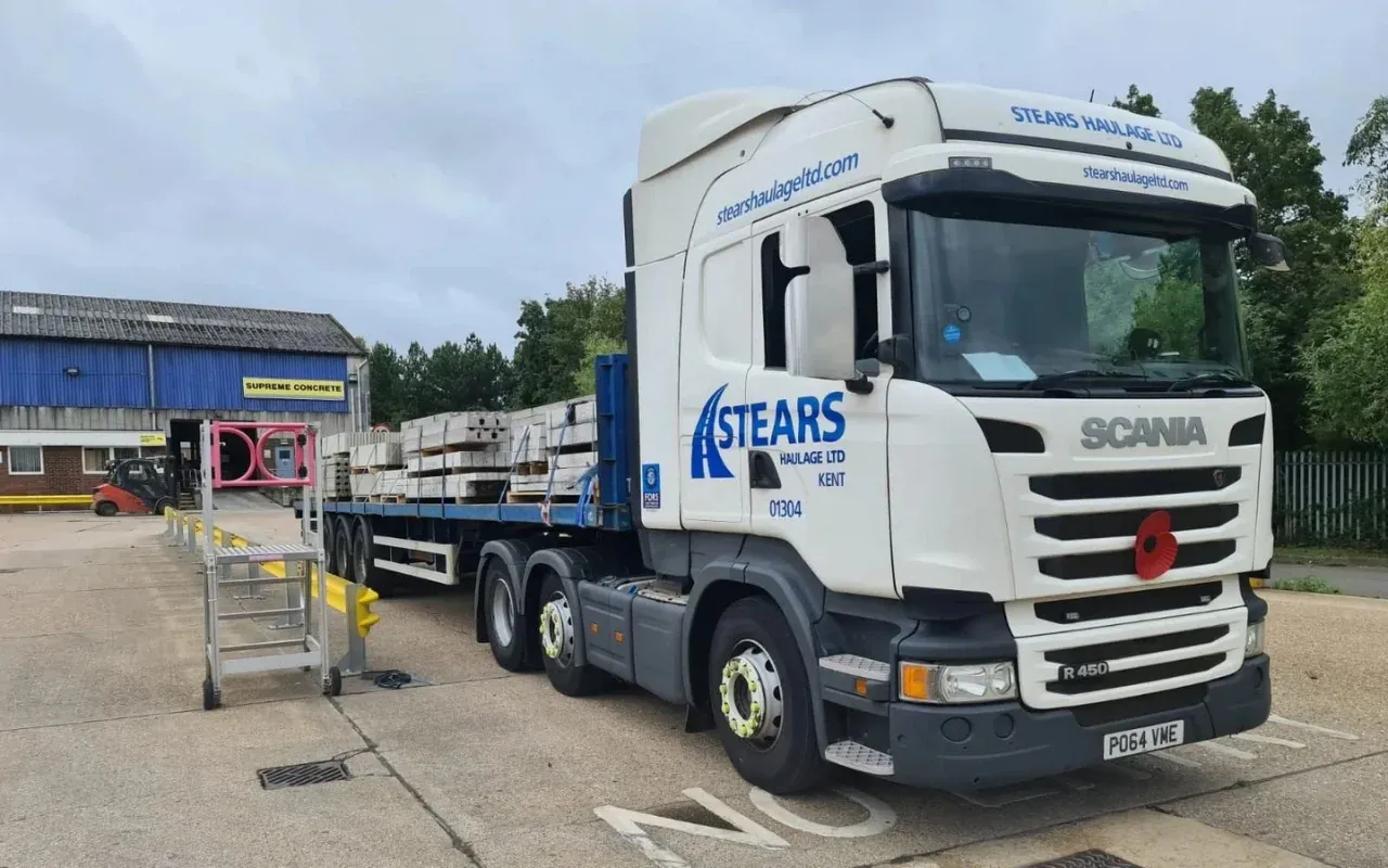 A Stears Haulage flatbed being loaded in a yard
